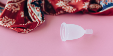 Menstrual cup on a pink surface 