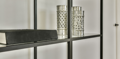 a book and three cup shaped materials on a bookshelf